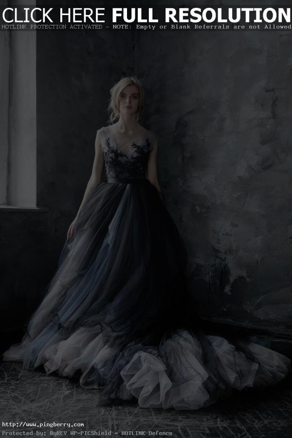 Darkly dramatic, this handmade gown features a sheer gray bodice entwined with b...